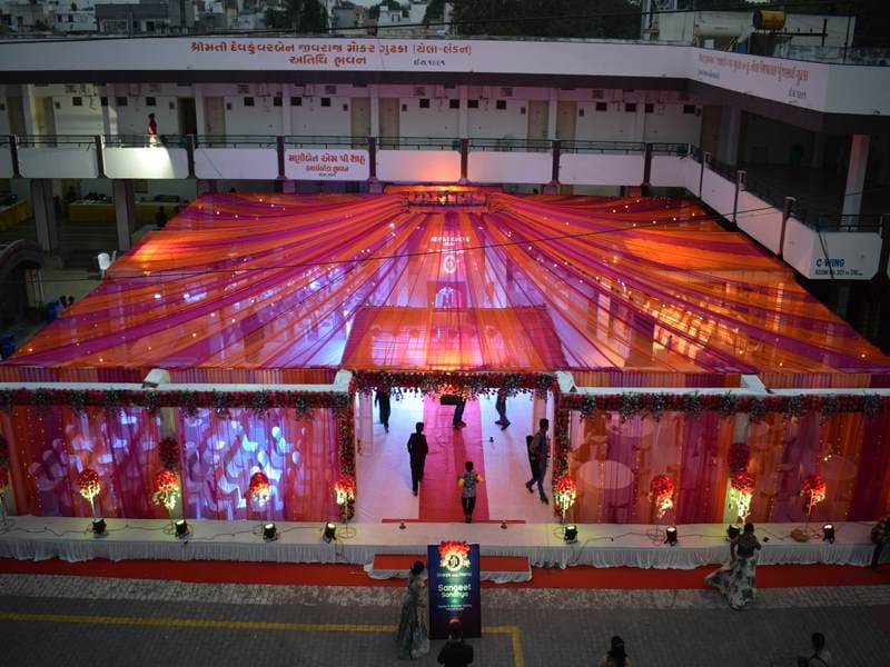 A pink and orange draped mandap canopy built by Anjan Enterprise